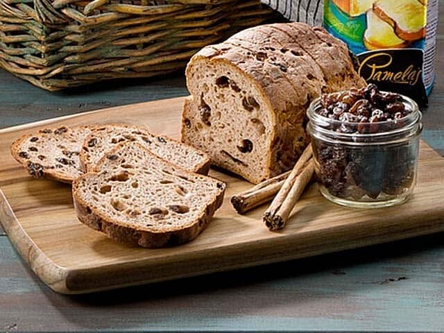 Gluten Free Raisin Bread with Cinnamon Sticks and a Jar of Raisins