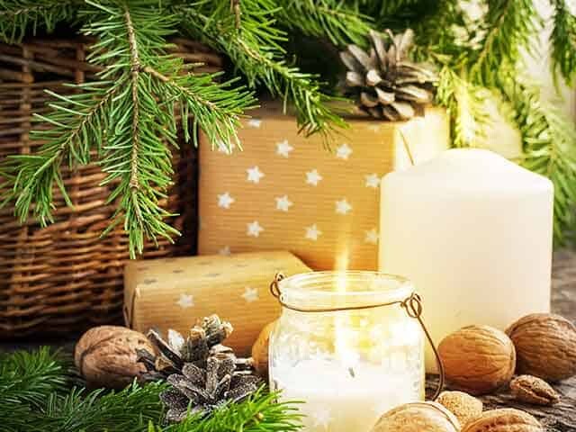 Candles, nuts, and presents underneath a pine tree