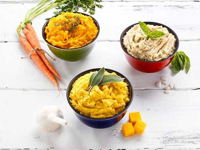 Bowls of holiday mashed items with ingredients on the side