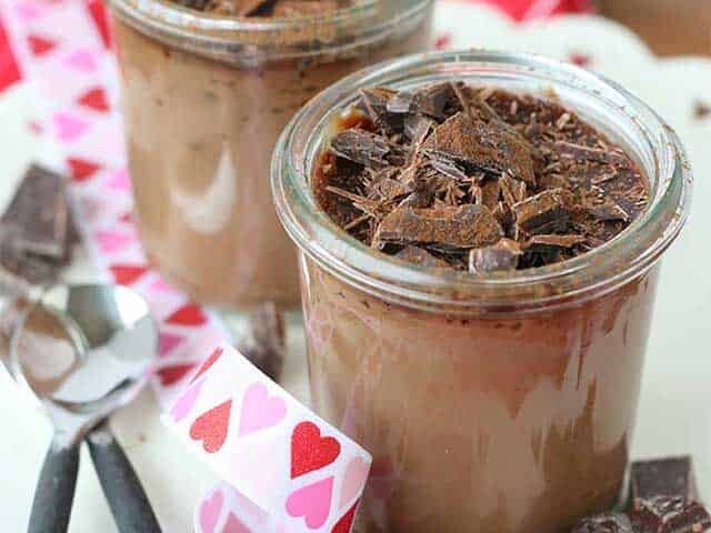 Chocolate Pots de Crème for Two with chunks of chocolate and spoons on the side