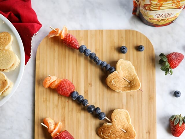 Pancake and fruit kabob arrows on cutting board