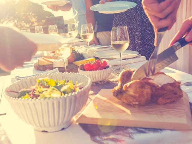 Someone carving a turkey on a buffet table