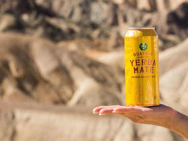 Hand holding Can of Guayaki Yerba Mate