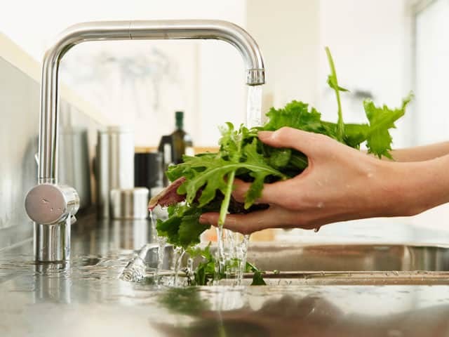 Washing vegetables in kitchen sink