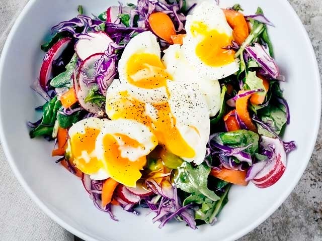 Paleo salad with eggs, lettuce, vegetables and radishes