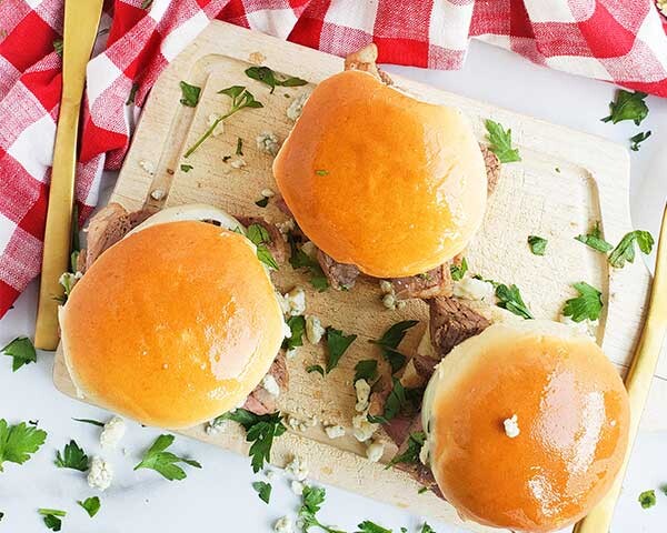 Sliders on a cutting board with checkered towel