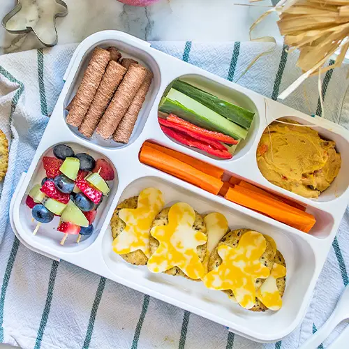 Veggies, crackers and cheese in a bento box