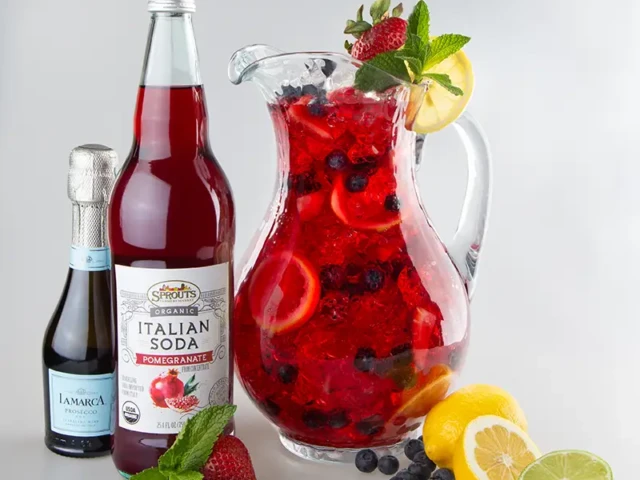 Berry spritzer ingredients next to a glass pitcher