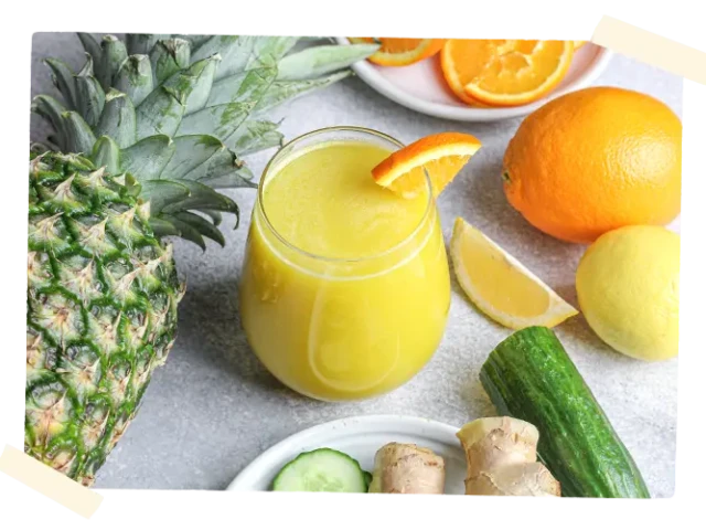 Juice in a glass surrounded by produce