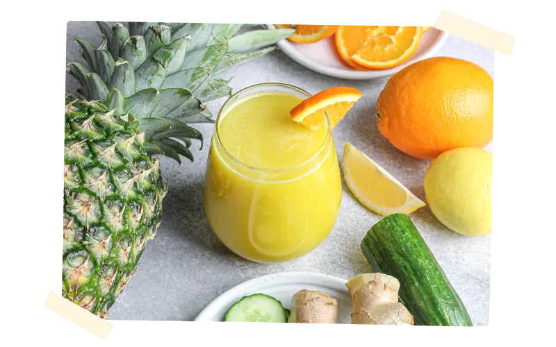 Juice in a glass surrounded by produce