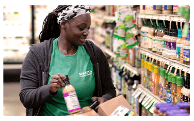 Sprouts store associate stocking items