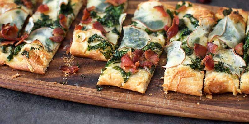 Kale Potato Bacon Pizza on a serving tray