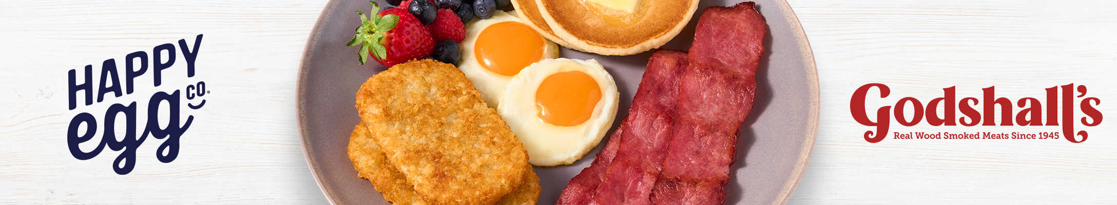 Happy Egg & Godshall's logos next to a plate of breakfast food