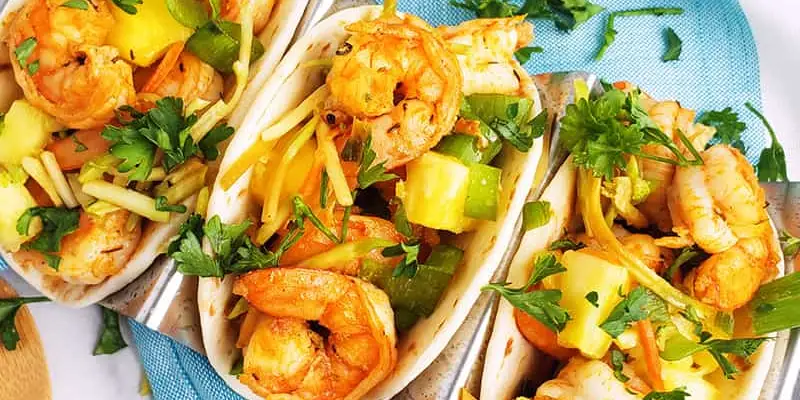 shrimp tacos on a blue plate