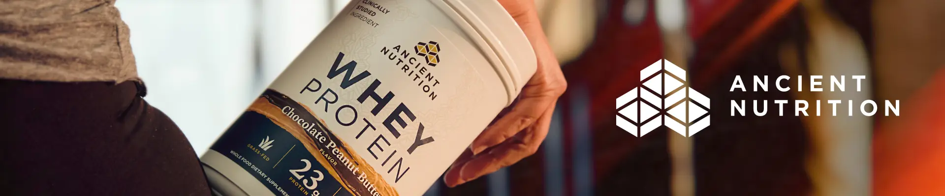 Ancient Nutrition logo next to bottle of protein